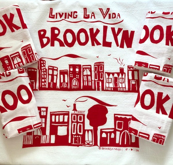 the words Living La Vida Brooklyn above an illustration depicting 2 rows of brownstone houses