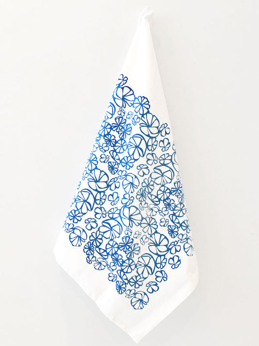 an image of a hanging kitchen towel decorated with an abstract floral design