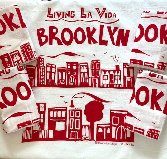 the words Living La Vida Brooklyn above an illustration depicting 2 rows of brownstone houses